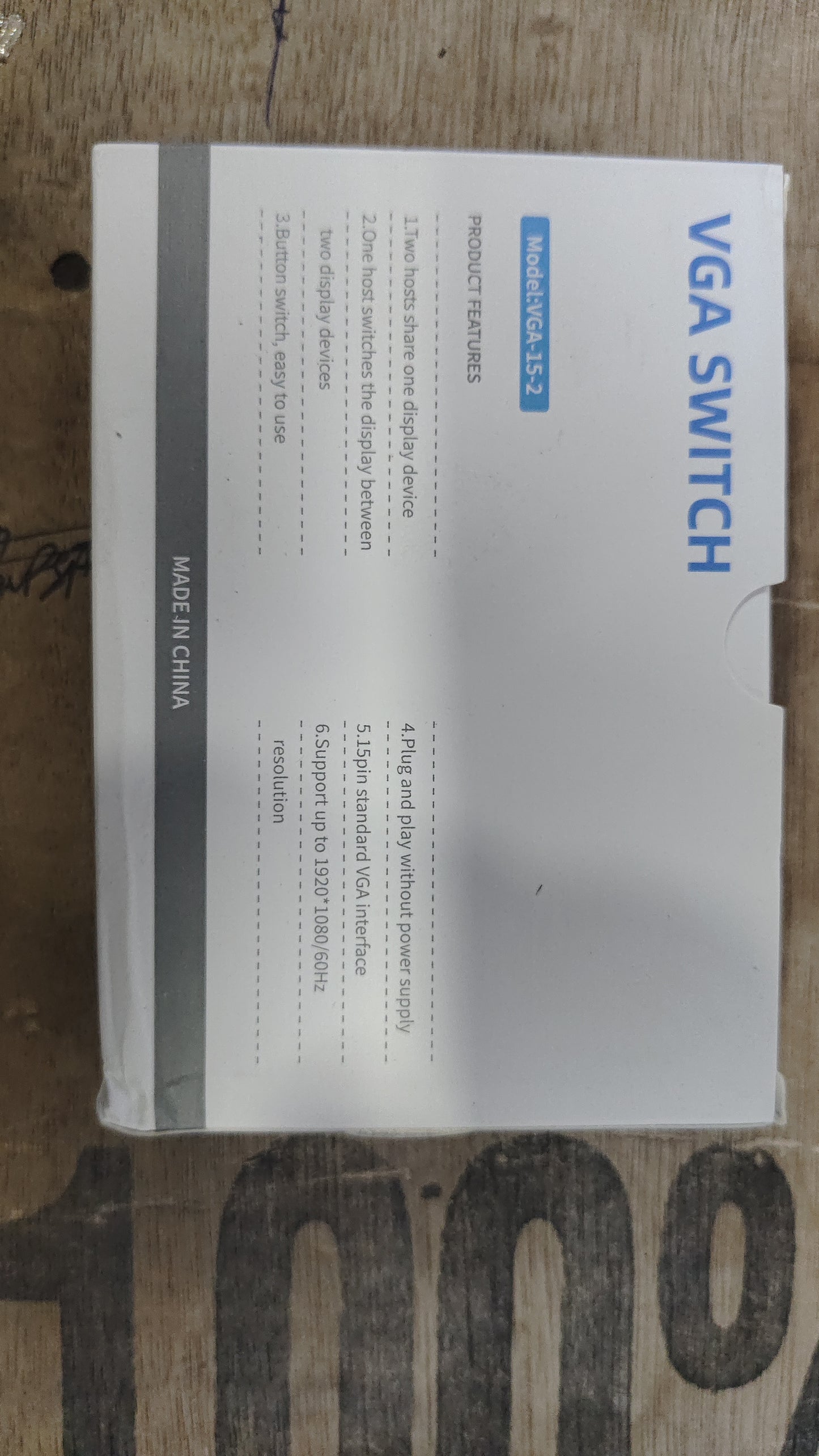 A 2-port VGA switch box with a blue and black color scheme, packaged in a cardboard box with the product name and a picture of the device displayed on the front.