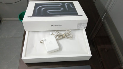 Apple MacBook Pro box and included power adapter and charging cable
