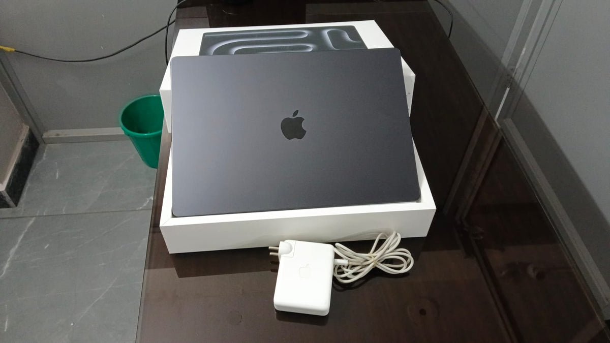 Refurbished Apple MacBook Pro space black lid and included charger