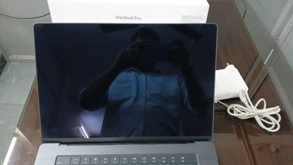 Apple MacBook Pro 16-inch display and included charger